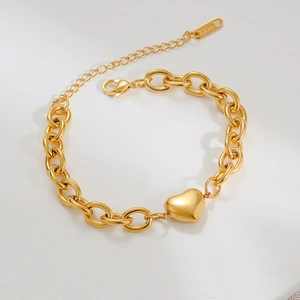 Detailed view of a gold plated stainless steel curb chain with a heart pendant and clasp