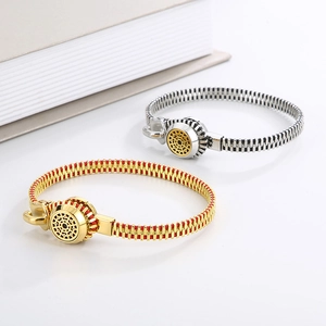 Detailed close-up of zipper-style titanium steel bracelets in gold and silver finish