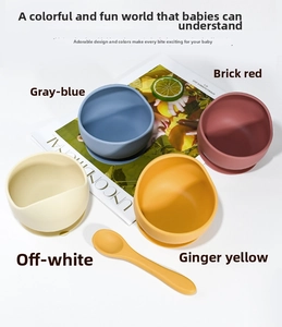 Set of four colorful silicone suction bowls and a matching spoon for baby feeding training