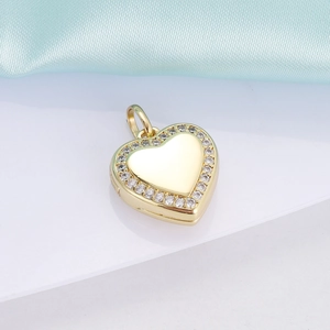 Macro shot of 18K gold heart pendant with sparkling crystals on silk background