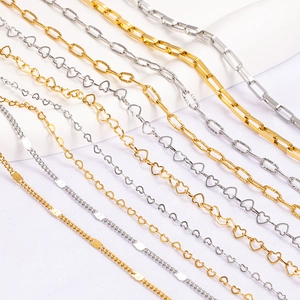 Macro view of various heart and geometric stainless steel chains in gold and silver