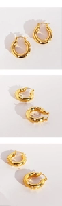 Detail view of gold round earrings with pearl accents and French vintage design