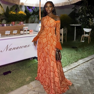 One-shoulder orange maxi dress with white geometric print and long flared sleeves