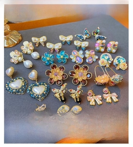 Macro shot of assorted crystal flower earrings and vintage baroque jewelry pieces