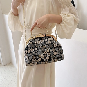 Elegant floral embroidered shell bag with gold metal handle and long chain shoulder strap