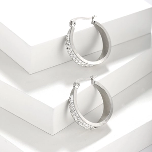 Macro shot of silver stainless steel hoop earrings with double row sparkling gemstones