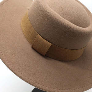 Brown wide brim wool felt boater hat with flat top and matching decorative ribbon band