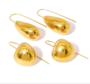 Close-up of polished 18K gold-plated teardrop and triangle earrings with hook backs
