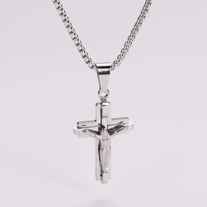 Macro detail of polished silver stainless steel crucifix pendant with 3D Jesus figure