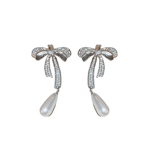 Silver bow necklace and pearl drop earrings set with sparkling zircon stones
