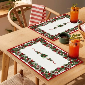 Close-up of Christmas placemat with holly and berries pattern on a wooden table