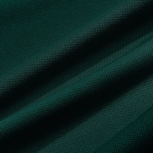 Detailed macro view of dark green moisture-wicking fabric with fine textured weave