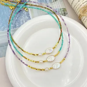 Detailed view of layered freshwater pearl necklaces with purple and turquoise beads
