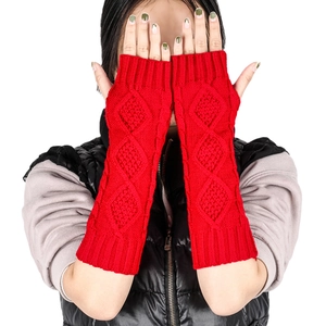 Macro detail of red diamond pattern knit arm warmer with fingerless design for winter