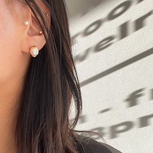 Baroque pearl drop earring with gold base on model, warm aesthetic minimalist style