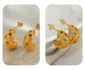 Detail of gold C-shaped hoop earrings with colorful zircons and two types of backings