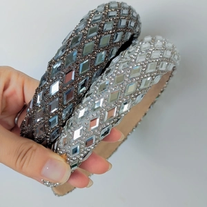 Close-up of wide velvet headbands with sparkling rhinestones in grey and silver colors