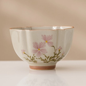 Daisy ceramic tea cup with floral pattern and elegant wavy rim for personal use