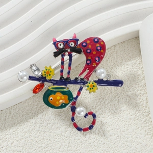 Detail of colorful enamel cat brooch with fishbowl, pearls and sparkling rhinestones