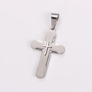 Macro view of silver stainless steel cross pendant with textured grid pattern detail