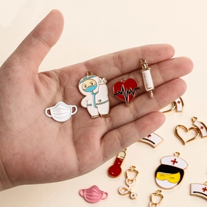 DIY medical charms featuring doctor, mask, and syringe icons on a palm for jewelry