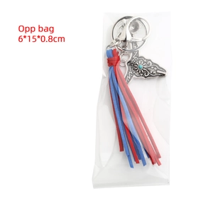 Detail of bohemian keychain with bull head pendant and colorful tassels in OPP packaging