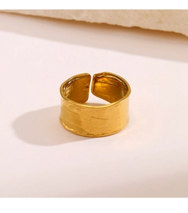 Macro view of gold stainless steel open ring with handcrafted hammered texture and glossy finish