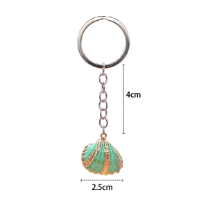 Bohemian beach shell keychain with mint green shell pendant and gold edging