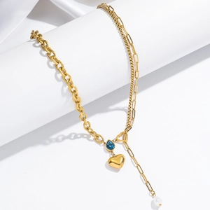 Golden heart necklace with blue water-drop gemstone and pearl tassel on a white pedestal