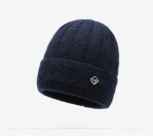 Close-up of deep blue knit beanie showing vertical ribbed texture and a metal WL logo