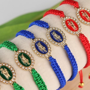 Detail of colorful hand-woven religious bracelets with crystal Virgin Mary charms