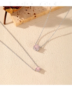Detail of silver S925 necklaces with pink rose-cut crystals on travertine stone