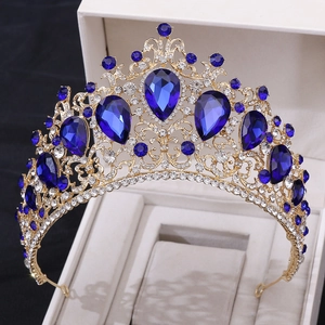 Golden baroque crown with blue crystals and rhinestones in white gift box centerpiece