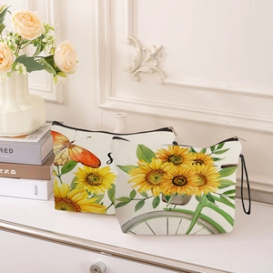 Sunflower 3D print canvas makeup bags set with zipper and wrist strap on a desk