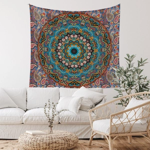 Detail of blue bohemian mandala tapestry hanging above a white sofa in a cozy room