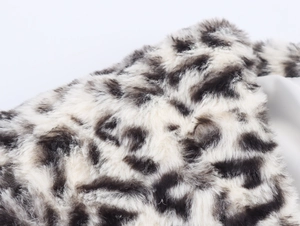 Detailed close-up showing the soft black and white leopard print faux fur texture