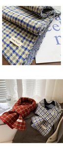 Close-up of a plaid knit scarf showing soft fabric texture and Trendy Scarf label detail