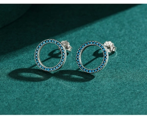 Macro shot of S925 sterling silver turquoise earrings showing the hallmark and blue stones