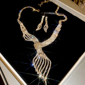 Detailed view of luxury leaf necklace and earring set with crystals in jewelry box