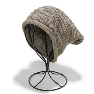 Close-up of khaki chunky knit beanie texture and thick weave pattern details