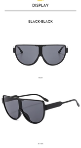 Front and 45-degree side views of black oversized shield sunglasses with one-piece lens