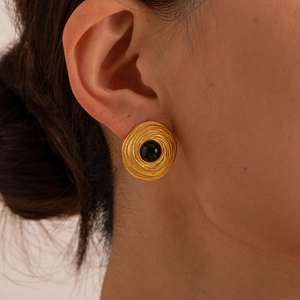 Retro gold coiled earrings with black onyx stone inlay shown on a female model