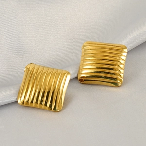 Golden square stainless steel earrings with geometric stripes on silk fabric
