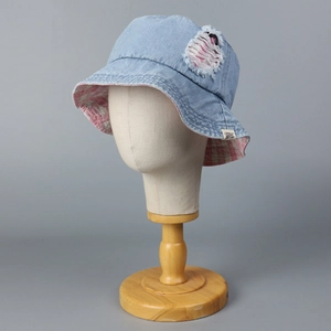 Light blue denim bucket hat with distressed ripped detail and pink plaid lining