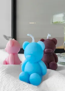 Detailed view of handmade mini bear scented candles in pink, blue, and brown shades