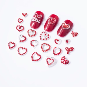 Detailed close-up of red and silver heart nail charms with Love and 520 engravings
