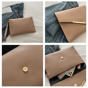 Detail view of khaki envelope clutch with gold metal trim and magnetic snap closure