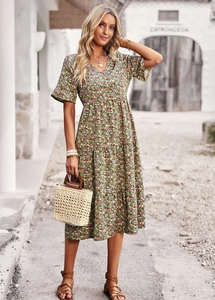 Elegant V-neck floral midi dress with short sleeves and tiered skirt in a green summer print