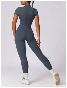 Detailed back view of dark blue yoga jumpsuit featuring a high neck and ergonomic slim fit