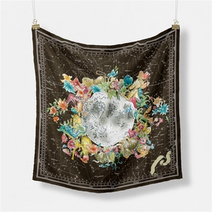 Detailed view of dark brown silk scarf featuring celestial lunar and zodiac patterns